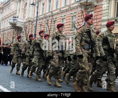 VILNIUS, Lithuania –Paratroopers from Able Company, 2nd Battalion, 503rd Infantry Regiment, 173rd Infantry Brigade Combat (Airborne), march through Vilnius during the Lithuanian Armed Forces Day Parade Nov. 23. The parade celebrated the 98th birthday of the Lithuanian Armed Forces. Lithuania gained its independence on Feb. 16, 1918. On Nov. 23, 1918, less than two weeks after the end of World War I, newly-elected Lithuanian Prime Minister, Augustinas Voldemaras, signed Order No. 1, which formed the armed forces of the newly-independent nation. Stock Photo