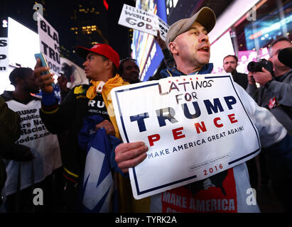 A Trump supporter makes his way through the crowds who gather to watch the election returns being broadcasted on giant video screens in Times Square on Election Day on November 8, 2016 in New York City. Democratic nominee Hillary Clinton and Republican candidate Donald J. Trump are battling to become the 45th US president following contentious campaigns.     Photo by Monika Graff/UPI Stock Photo