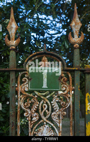 Metal house number 1 sign plate mounted on rusting cast iron fence at Qunita do Regóio Palace, Rua Trindade Coelho 1-2, 2710-567 Sintra, Portugal. Stock Photo