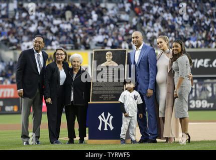 Retired New York Yankees players Mariano Rivera watches Paul O'Neill and  his wife Nevalee unveil a plaque at a ceremony inducting O'Neill into  Monument Park before the game against the Cleveland Indians