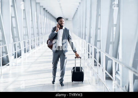 Always in Touch. Entrepreneur Talking on Phone in Airport Stock Photo