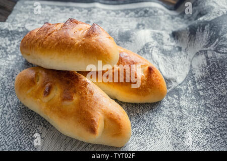 Freshly baked fragrant homemade small meat pies with an appetizing crust. Russian national cuisine. Stock Photo