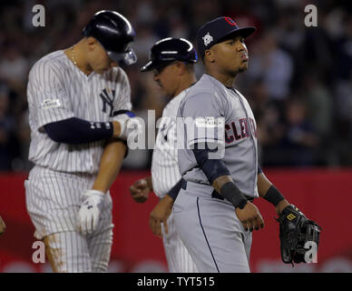 Cleveland Indians Jose Ramirez stands next to New York Yankees Aaron Judge  who puts his thumb down when he reacts after driving in 2 runs with a  double in the 3rd inning