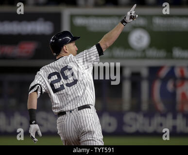 New York Yankees batter Todd Frazier follows through after hitting a  three-run home run against the Houston Astros in the second inning in game  3 of the 2017 MLB Playoffs American League