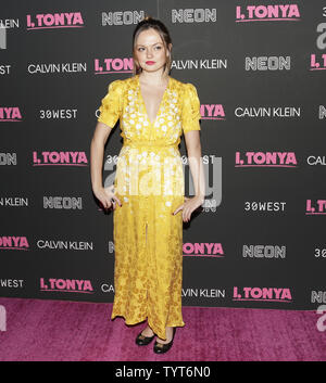 Emily Meade arrives on the red carpet at the American Hustle premiere