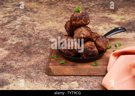 pile of meatballs in cast iron frying pan Stock Photo