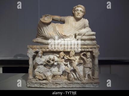 Reclining Man with Omphalos Bowl. Etruscan alabaster cinerary urn with a lid from the grave of the Calisna Sepu family dated from around 150 BC found in Malacena (Monteriggioni), now on display in the Altes Museum in Berlin, Germany. The death of Myrtilus is depicted in the relief bellow. Stock Photo