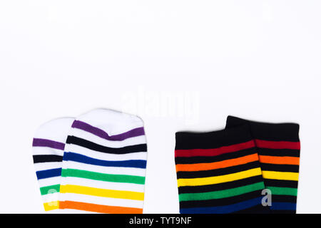 Two clean white and black pair of socks with striped pattern on white background with copy space. Flat lay. Top view. Fabric cotton clothes for feet. Stock Photo