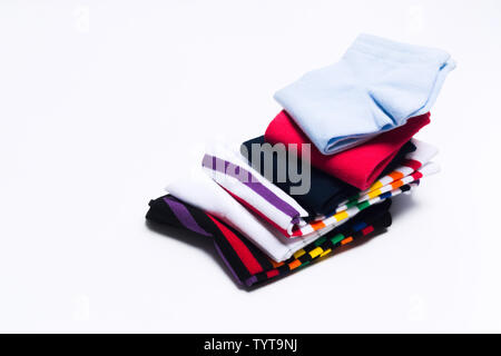 Different colorful socks in one stack for kids or woman. Fashion warm clothes for feet. Selective focus Stock Photo