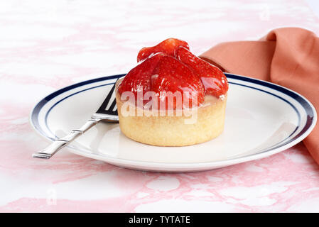 strawberry custard glazed tart on a plate Stock Photo