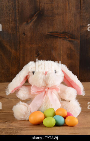 stuffed easter bunny with colorful eggs Stock Photo