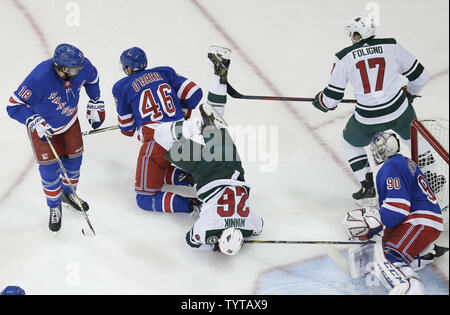 New York Rangers Alexandar Georgiev and Marc Staal watch Minnesota Wild Daniel Winnik fall over Rob O'Gara in the first period at Madison Square Garden in New York City on February 23, 2018.     Photo by John Angelillo/UPI Stock Photo