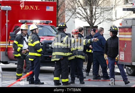 FDNY firefighters continue to work at the scene of a five-alarm fire ...