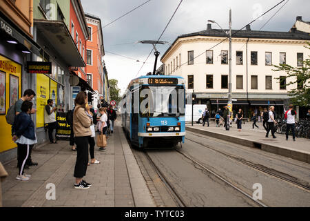 A number 12 tram stops to pick up passengers on Thorvald Meyers Gate in the Grünerløkka neighborhood of Oslo, Norway. Stock Photo