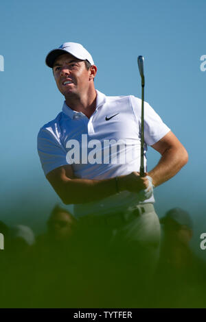 Rory McIlroy watches his drive from the first tee during round-robin ...