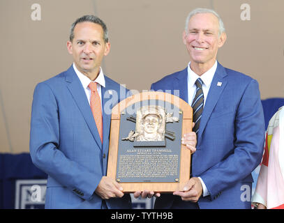 Trevor Hoffman and President of the Baseball Hall of Fame Jeff Idelson  holds his plaque before he delivers his Baseball Hall of Fame induction  speech at the Clark Sports Center in Cooperstown