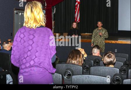 Erica Thomas presents her concern about the danger at a cross walk used by her children during the Town Hall Meeting at the base theater on  Marine Corps Air Station New River Nov. 29. The meeting was comprised of sections and shops of the Air Station who had representatives speak to the residents of Marine Corps Air Station New River and receive feedback for any goods and services available. Thomas is a resident of Marine Corps Air Station New River. Stock Photo
