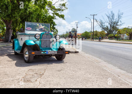 Varadero, Cuba - May 8, 2019: Classic Old Taxi Car in the street during a vibrant and bright sunny day.