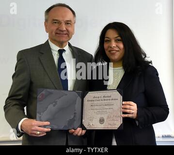 Dr. Andrew Michta, dean with the College of International Security Studies at the George C. Marshall European Center for Security Studies, presents Ulpia Botezatu, an analyst with the Space Critical Infrastructures Department of the Romanian Space Agency, with certificate for completing the Central and Southeast Europe Fellow Program Nov. 29. (Marshall Center Stock Photo