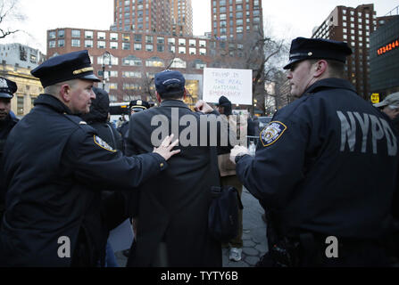 A counter protester is removed when protesters gather in Union Square for the 'No To Fake Emergency' protest on February 18, 2019 in New York City.  Americans across the country protest to send President Donald Trump a message that his declaration of a national emergency on the U.S.-Mexico border is false.  Photo by John Angelillo/UPI Stock Photo