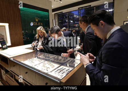 Attendees look at Rolex watches at the Grand Opening of Hudson