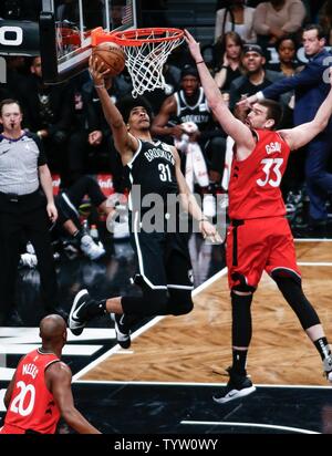 Brooklyn Nets center Jarrett Allen (31) puts up a shot against Toronto Raptors center Marc Gasol (33) in the first half at Barclays Center in New York City on April 3, 2019.       Photo by Nicole Sweet/UPI Stock Photo