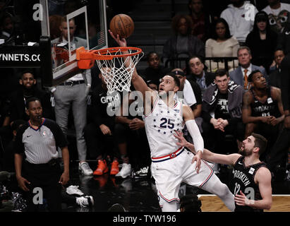 Philadelphia 76ers guard Ben Simmons, center, shoots over Brooklyn Nets guard Joe Harris, left, during the second half  game between the Philadelphia 76ers and the Brooklyn Nets in Game 3 of their first-round playoff series at Barclays Center in New York City on April 18, 2019.       Photo by Peter Foley/UPI Stock Photo