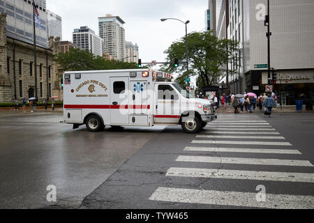 Chicago Fire Department emergency ambulance on call on a wet day in downtown Chicago IL USA Stock Photo