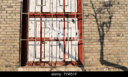 Nostalgic brick walls, mottled tree shadows Stock Photo