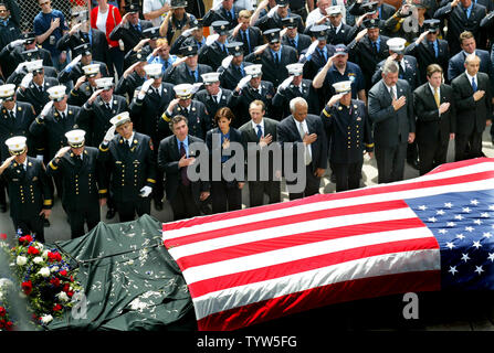 SPT11ANN25  - WASHINGTON, Aug. 19 (UPI) - FILE PHOTO - May 30, 2002 -  Fire and police personnel pay homage to a flag-draped beam, the final piece of debris to be removed from Ground Zero, during the closing ceremony marking the end of the cleanup effort at the World Trade Center on May 30, 2002, in New York City.  jaf/mg/Monika Graff Stock Photo