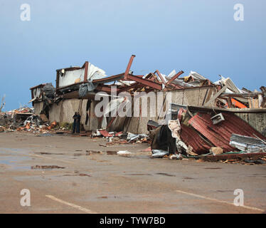 A path of destruction is seen in the aftermath of a series of tornadoes ...