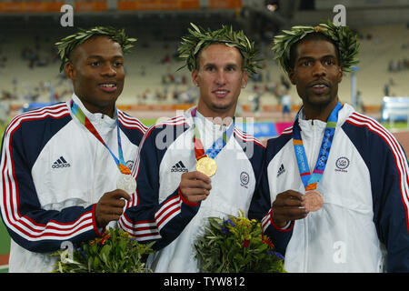 On the podium L. to R. Otis Harris (silver), Jeremy Wariner (gold) and Derrick Brew (bronze) a clean sweep by the USA in men's 400m in the Olympic Stadium at the 2004 Athens Summer Olympic Games, August 23, 2004.  (UPI Photo/ Claus Andersen) Stock Photo