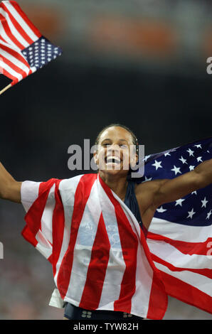 American hurdler Joanna Hayes takes a victory lap after capturing the ...