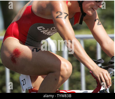 Canadian triathlete Jill Savege perseveres through the Olympic triathlon course after suffering a nasty fall from her bicycle in the first lap of the cycling segment at the Vouliagmeni Olympic Centre on August 25, 2004.  Savege finished the race in 39th place out of the 50 women starters.  (UPI Photo / Grace Chiu) Stock Photo