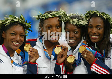 On the podium the USA 4x400m relay gold medal winners L. to R. Monique Henderson, DeeDee Trotter, Monique Hennagan and Sanya Richards in the Olympic Stadium at the 2004 Athens Summer Olympic Games, August 28, 2004.  (UPI Photo/ Claus Andersen) Stock Photo