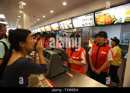 McDonaldÕs employees work the counter at a new McDonald's on the Olympic Green in Beijing on August 7, 2008.  McDonald's is the official restaurant of the Olympic Games.  (UPI Photo/Terry Schmitt) Stock Photo