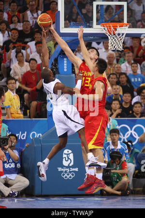 USA's Kobe Bryant (L) has a shot blocked by China's Yao Ming in the first half of USA vs. China basketball at the 2008 Olympics in Beijing on August 10, 2008.  The USA won 101-70.   (UPI Photo/Terry Schmitt) Stock Photo