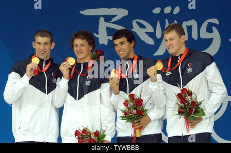 USA's Michael Phelps, Ryan Lochte, Ricky Berens and Peter Venderkaay (L to R) show off their gold medals for a world-record-setting performance in the Men's 4x200M Relay at the National Aquatic Center (Water Cube) during the 2008 Summer Olympics in Beijing, China, on August 13, 2008. The effort earned Phelps his fifth gold medal.   (UPI Photo/Roger L. Wollenberg) Stock Photo