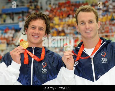 USA's Ryan Lochte shows off his gold medal along with silver medalist Aaron Peirsol (R) for the Men's 200 meter Backstroke at the National Aquatics Center at the Summer Olympics in Beijing on August 15, 2008.  Lochte won in a World Record time of 1:53.94.   (UPI Photo/Pat Benic) Stock Photo