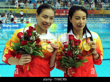 China's Minxia Wu (L, bronze) and Jingjing Guo (gold) hold their medals earned in the Women's 3M Springboard final at the National Aquatic Center (Water Cube) during the 2008 Summer Olympics in Beijing, China, on August 17, 2008.    (UPI Photo/Roger L. Wollenberg) Stock Photo