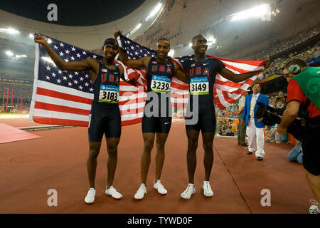 USA's Angelo Taylor (C), Kerron Clement  (R) and Bershawn Jackson celebrate sweeping all the medals in the men's 400m hurdles final during Olympic athletics in Beijing August 18, 2008.  Taylor won gold with a time of 47.25, Clement took silver in 47.98 while Jackson grabbed the bronze in 48.06.  (UPI Photo/Stephen Shaver) Stock Photo