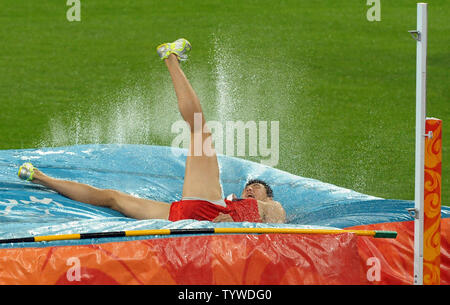 China's Qi Haifeng lands in the sand during the Long Jump part of the ...