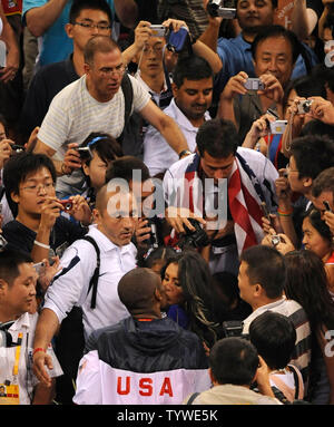 Team USA's Kobe Bryant (in USA jersey) gets a kiss from his wife as the fans press in at the conclusion of the men's basketball final, which the USA won, beating Spain, 118-107, at the Olympic Basketball Gymnasium, August 24, 2008, at the Summer Olympics in Beijing, China.     (UPI Photo/Mike Theiler) Stock Photo