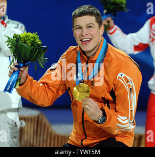 Sven Kramer of the Netherlands (gold) celebrates his medal in men's 5000 meter speed skating during a Medal Ceremony at BC Place in Vancouver, Canada, during the 2010 Winter Olympics on February 14, 2010.     UPI/Roger L. Wollenberg Stock Photo