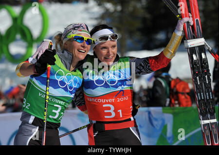 Germany's Claudia Nystad (L) and teammate Evi Sachenbacher-Stehle celebrates after taking gold in the Women's Cross-Country Team Sprint at the 2010 Vancouver Winter Olympics in Whistler, Canada on February 22, 2010. UPI/Kevin Dietsch Stock Photo