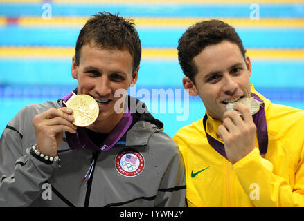 USA's Ryan Lochte and Brazil's Thiago Pereira (R) enjoy their gold and silver medals after the Men's 400 Individual Medley Final at the Aquatics Center during the London 2012 Summer Olympics in Stratford, London on July 28, 2012.    Lochte's winning time was 4:05.18   UPI/Pat Benic Stock Photo