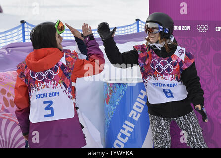 Switzerland's Sina Candrian (L) and Great Britain's Jenny Jones high-fives Finland's Enni Rukajarvi after her run in the Ladies' Slopestyle final during the Sochi 2014 Winter Olympics on February 9, 2014 in Krasnaya Polyana Russia. Rukajarvi won a silver medal while Jones won a bronze in the event.        UPI/Brian Kersey Stock Photo