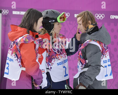 The Czech Republic's Sarka Pancochova (R) talks with Great Britain's Jennie Jones (C) and Switzerland's Sina Candrian after her run in the Ladies' Slopestyle final during the Sochi 2014 Winter Olympics on February 9, 2014 in Krasnaya Polyana Russia. Pancochova fell on her run, breaking her helmet.        UPI/Brian Kersey Stock Photo