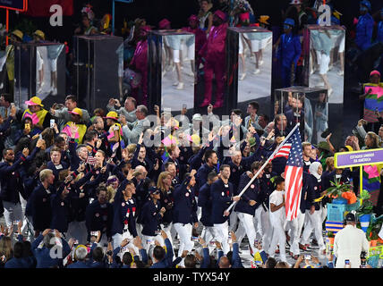 Michael Phelps holds the American flag as he leads the United States in the arena at the Opening Ceremony of the 2016 Rio Summer Olympics begins in Rio de Janeiro, Brazil on August 5, 2016.     Photo by Kevin Dietsch/UPI Stock Photo