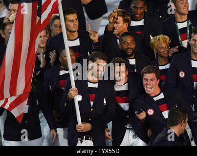 Michael Phelps holds the American flag as he leads the United States in the arena at the Opening Ceremony of the 2016 Rio Summer Olympics begins in Rio de Janeiro, Brazil on August 5, 2016.     Photo by Terry Schmitt/UPI Stock Photo